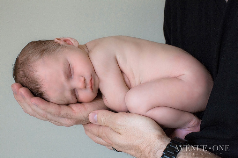 newborn baby in dad's hands