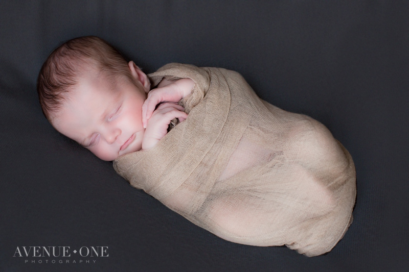 newborn wrapped with smooth background