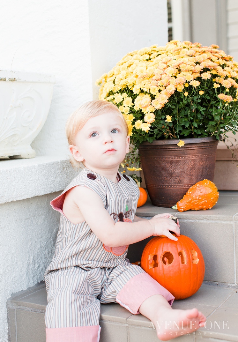 boy on step with pumpkin