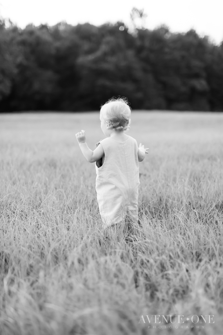 little boy singing in field