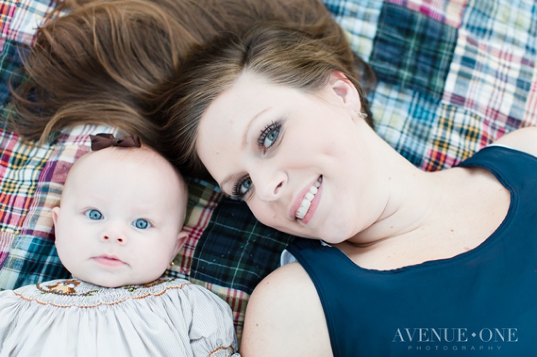 mom and baby on laying on picnic blanket