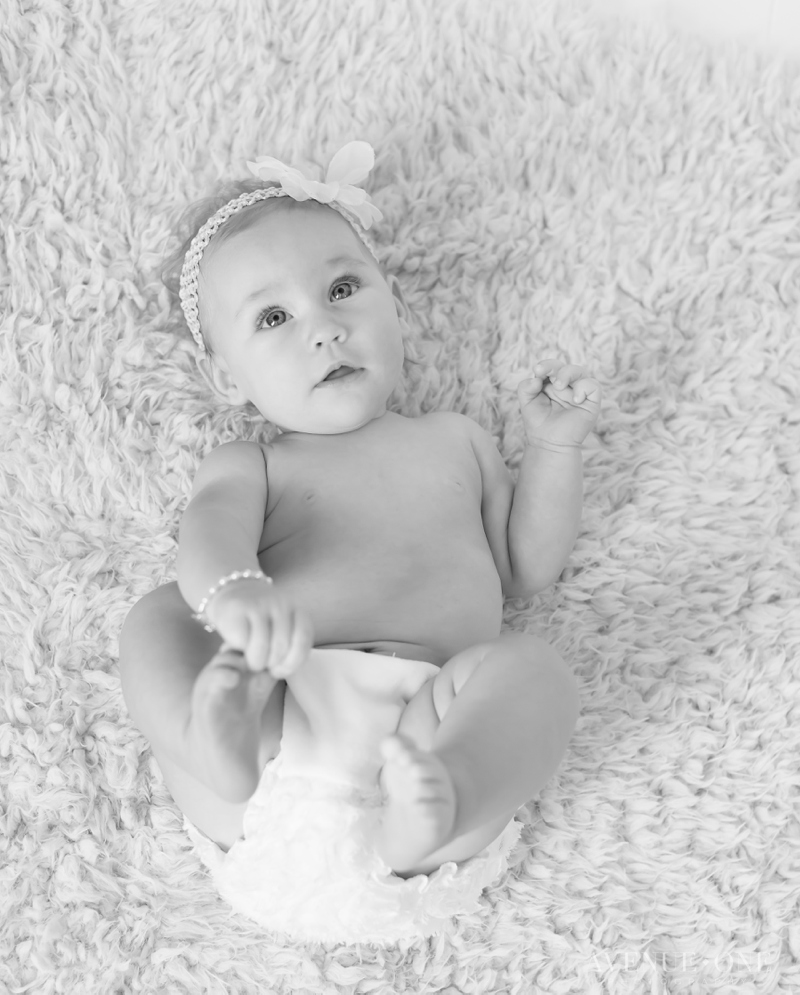 six month baby holding feet