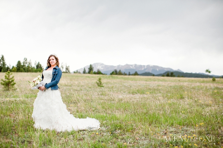 bride with jean jacket in field