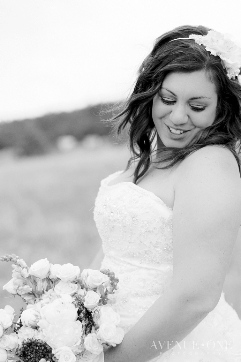 bride looking over shoulder in field