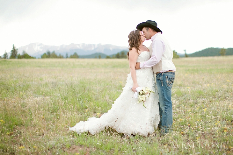 bride and groom with mountains behind