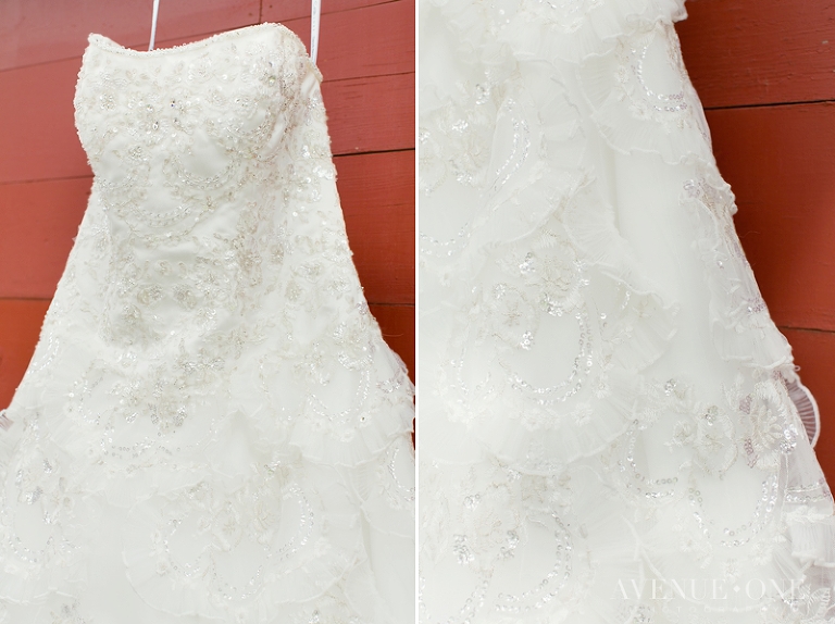 wedding dress hanging on red barn