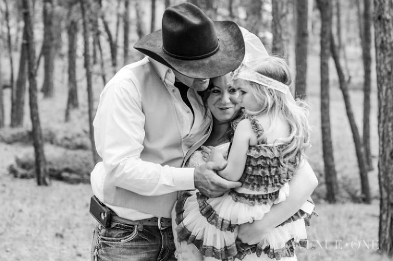 bride and groom holding flower girl