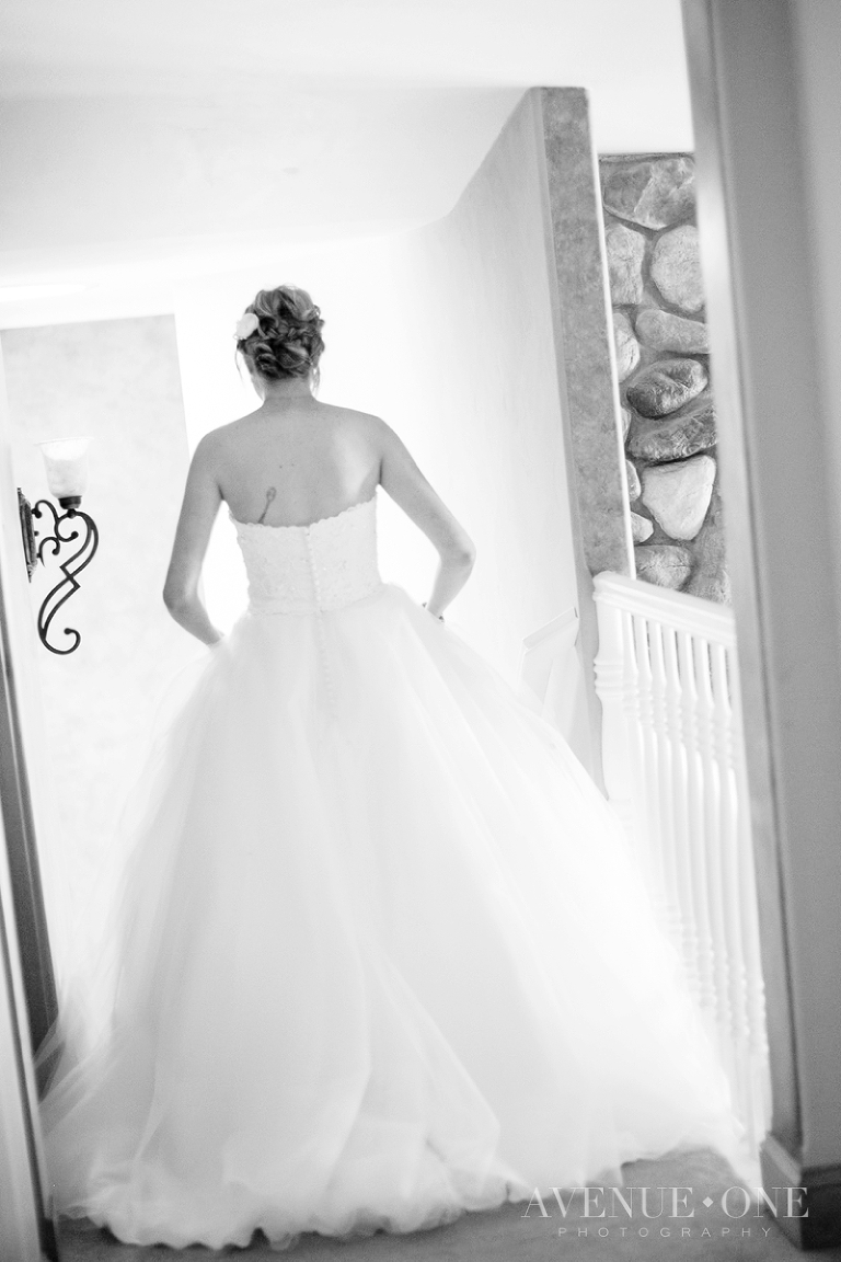 bride walking down stairs for first look
