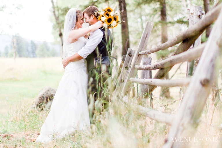 bride and groom by old wooden fence