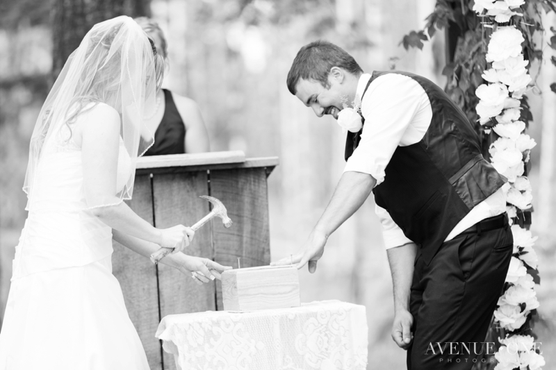 bride and groom nailing wine box during ceremony