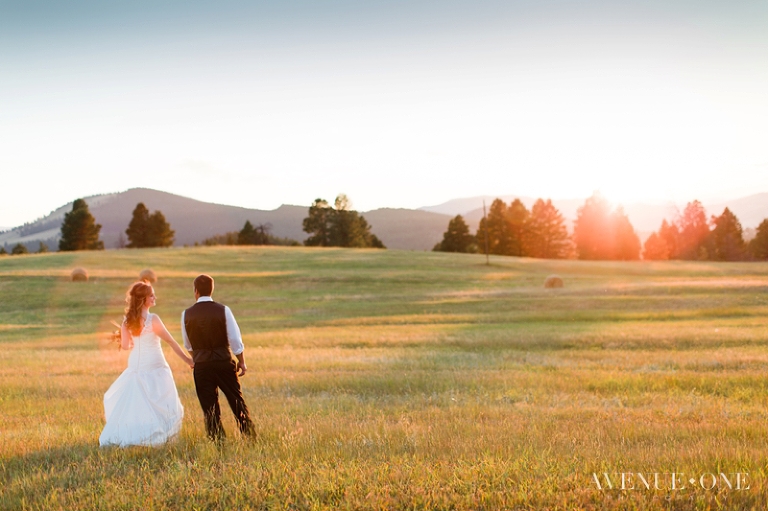 Colorado bride and groom walking through field