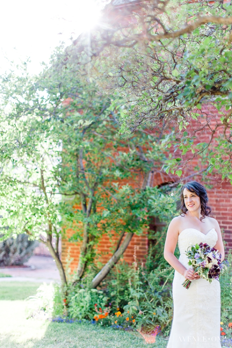 bride in front of brick house