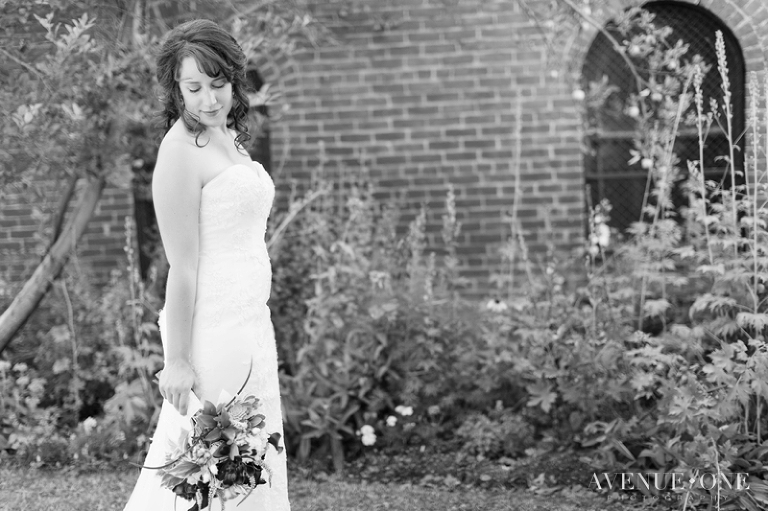 bride looking down at purple bouquet