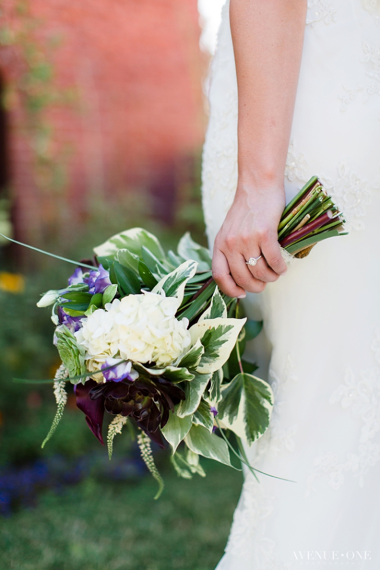 bride's engagement ring holding flowers