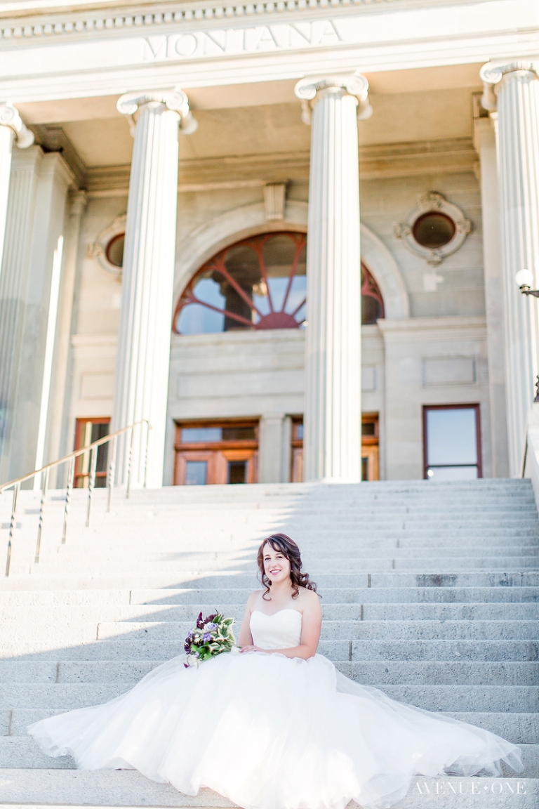 bride sitting on stone steps